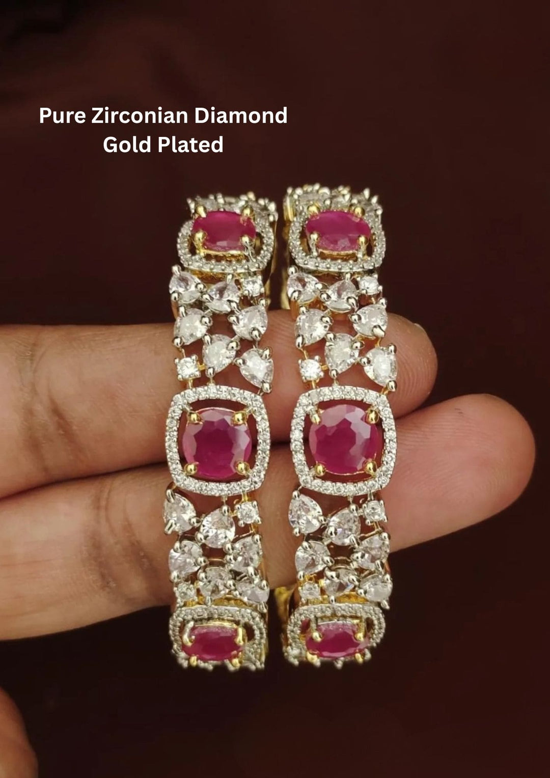 Gold and diamond bangles with red gemstones