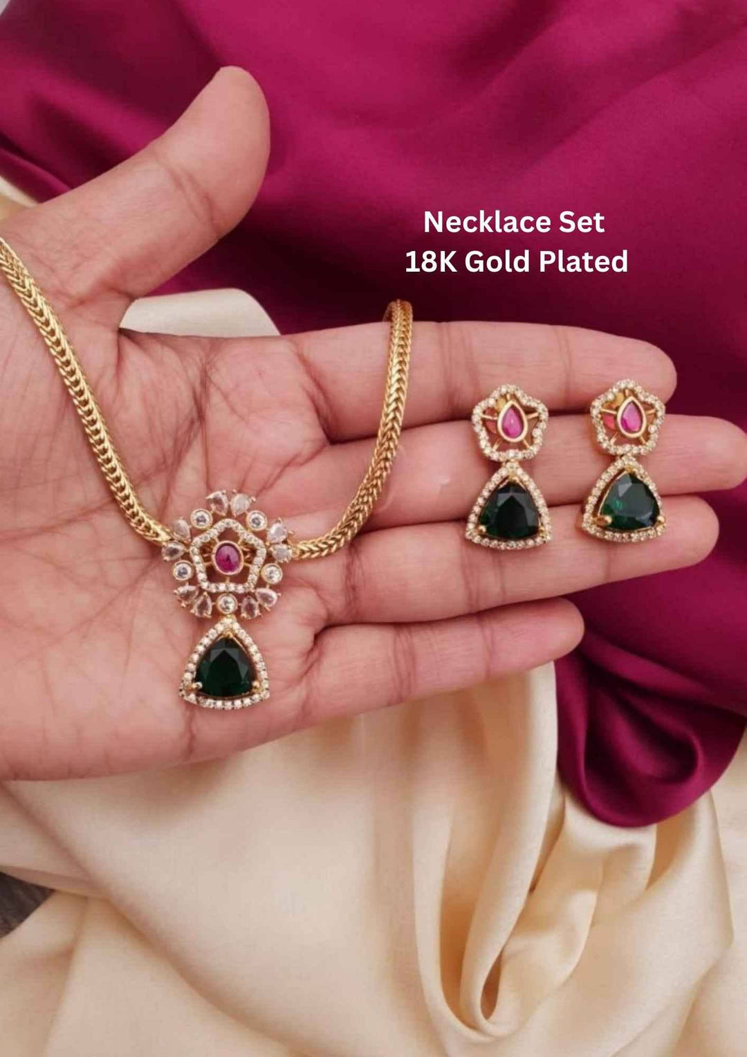 Gold necklace and earrings set with gemstones 