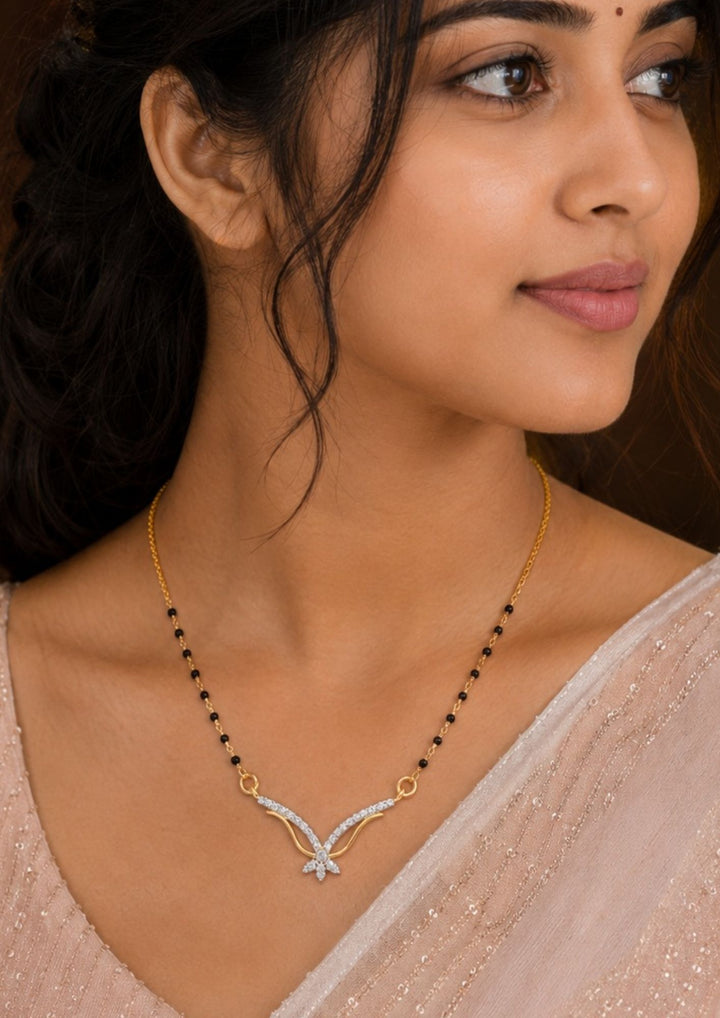 South Indian Woman wearing Gold plated black beads mangalsutra featuring an elegant butterfly-inspired zircon centerpiece with delicate curved detailing. Lightweight and beautifully crafted for everyday elegance, festive occasions, and gifting.