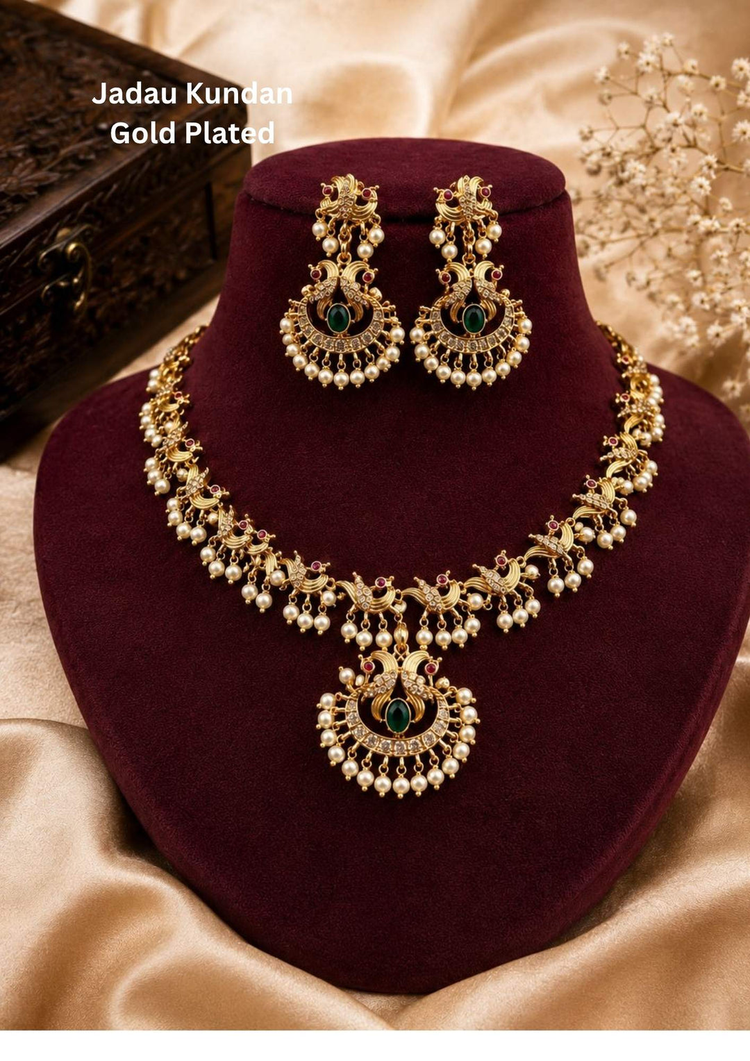 Traditional style gold plated Jadau short necklace set designed with a black dori cord, stone-studded paisley links, and a crescent chandbali Laxmi pendant featuring pink, green, and white stones with dangling pearl clusters that give a graceful traditional look for festive celebrations, poojas, family functions, and bridal outfits.