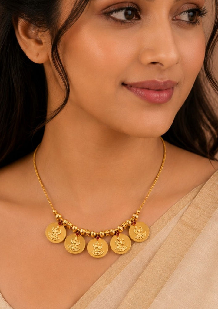 South Indian Woman wearing a Gold plated Laxmi coin necklace featuring traditional Lakshmi motif coins with elegant temple-inspired craftsmanship. Perfect for festivals, poojas and traditional occasions.