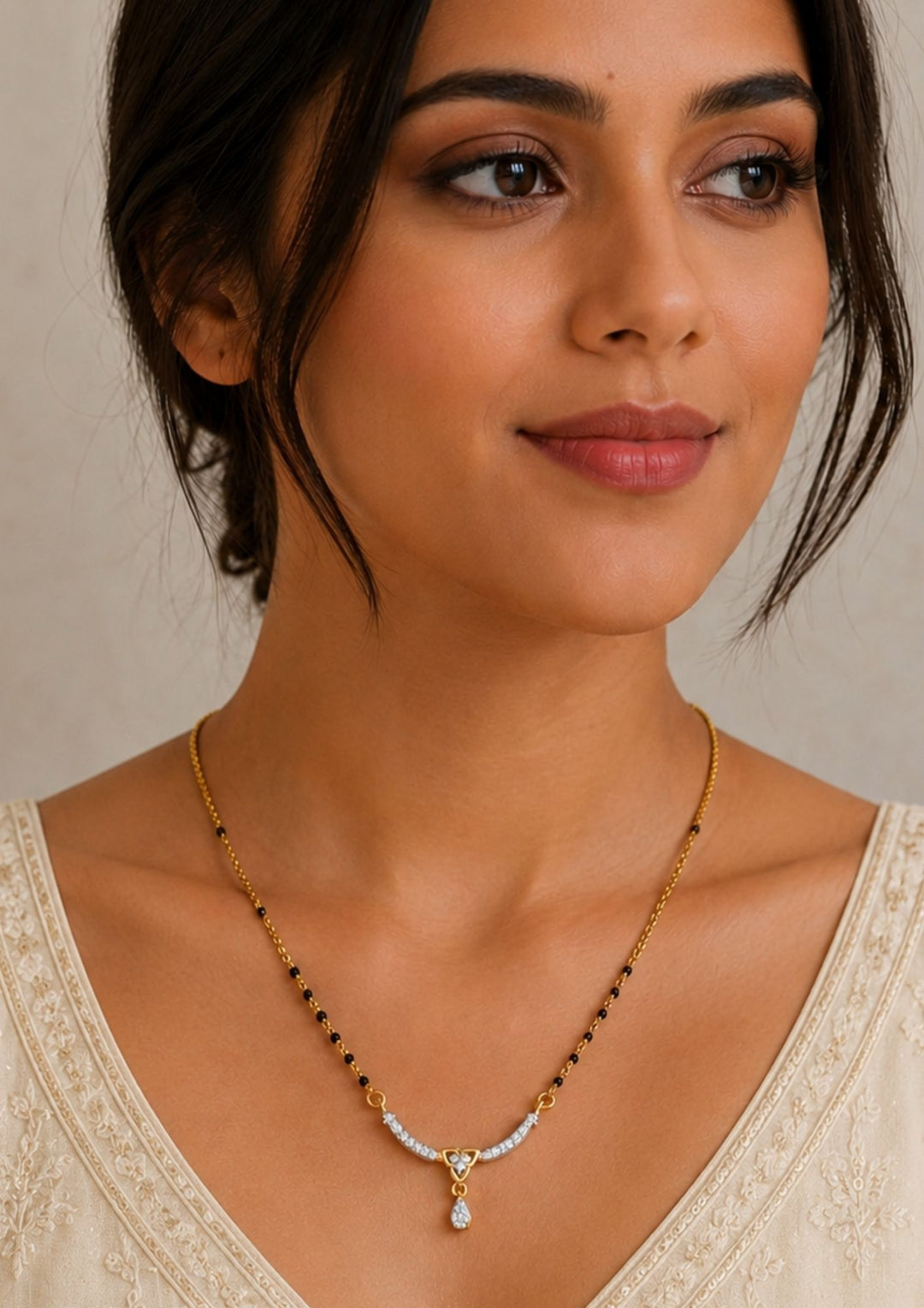 South Indian Woman wearing a Gold plated black beads mangalsutra featuring an elegant heart-shaped zircon centerpiece with a delicate drop pendant. Designed with a graceful 18–20 inch chain, making it perfect for daily wear, festive occasions, and gifting.