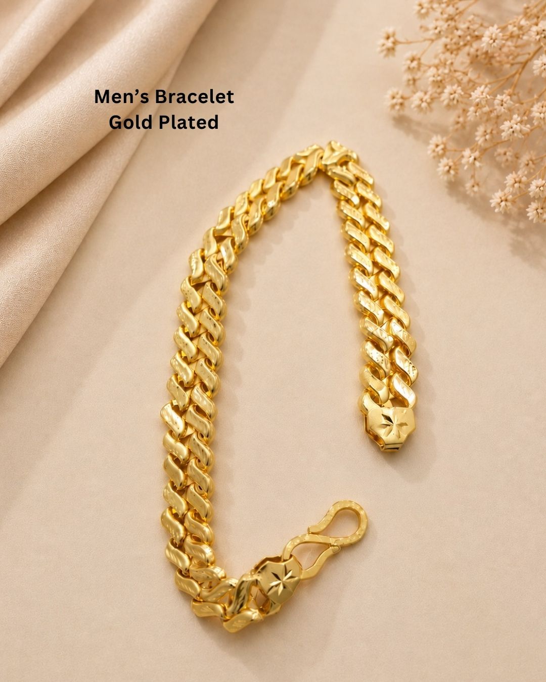 A close-up of a gold Cuban link chain bracelet worn on a person&
