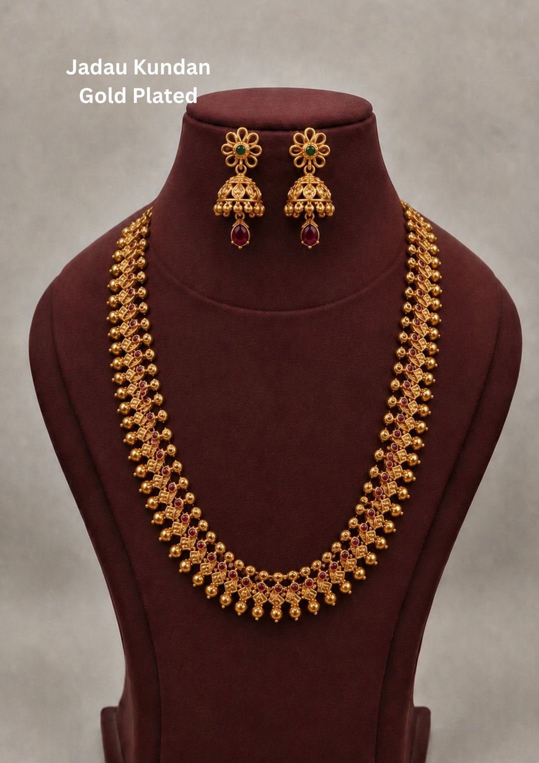 Traditional style gold plated temple long haram necklace designed with structured Nakshi panels  green bead accents, and an elegant matte gold finish that gives a graceful traditional look for festive celebrations, poojas, family functions, and bridal outfits.