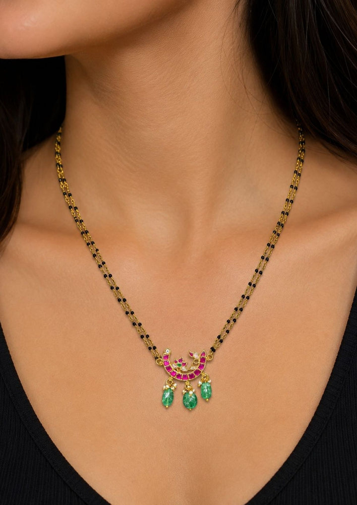 lack beads mangalsutra chain featuring a slim gold plated chain with evenly spaced traditional black beads and a curved center pendant decorated with tiny dangling zircon stones. The lightweight 18 to 20 inch necklace gives a modern minimal look suitable for daily wear, office wear, married women, festive occasions and traditional outfits.