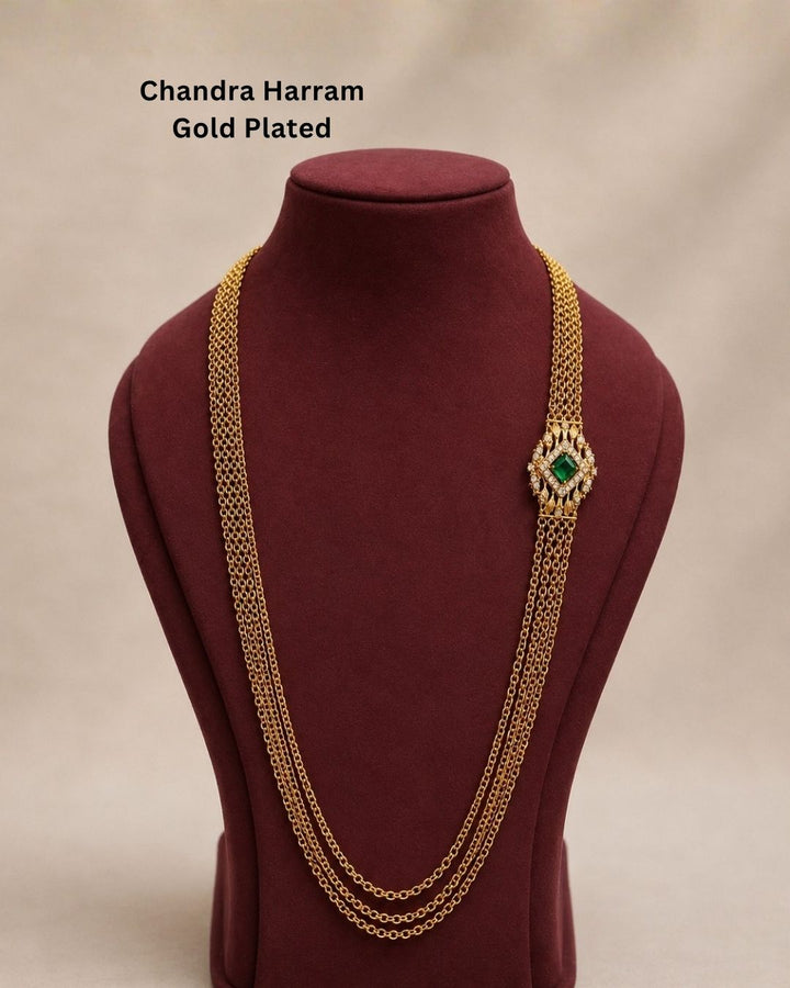 Beautiful multi-layer Chandra Haram gold plated necklace featuring a rich green center stone and sparkling accents. Perfect for traditional outfits, festive occasions, temple visits, weddings, and special events.
