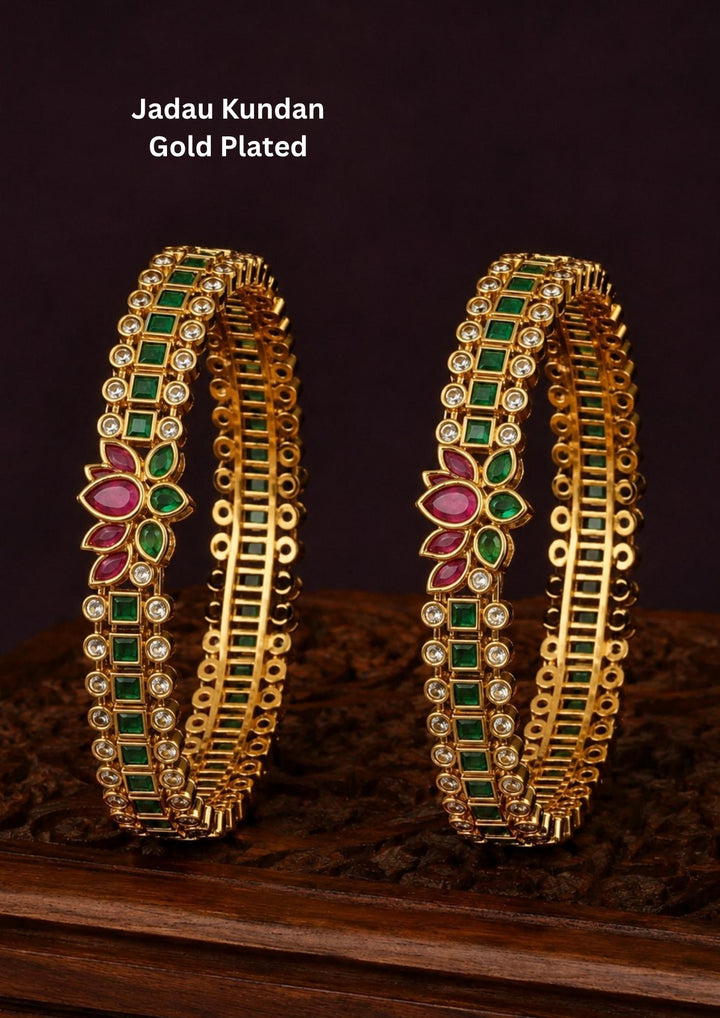 Designer emerald floral bangles with brilliant zircon stones and vibrant ruby-inspired floral motifs.
Expertly crafted with premium gold plating for a luxurious traditional appearance.
Perfect for weddings, festivals, ethnic wear, and gifting.