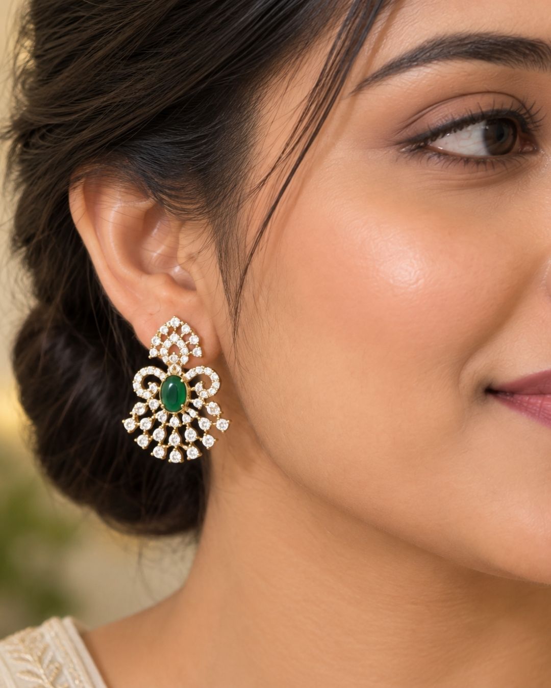 Gold-plated pendant necklace and matching earrings The pendant and matching earrings feature intricate silver-toned filigree with green stone accents in the center.