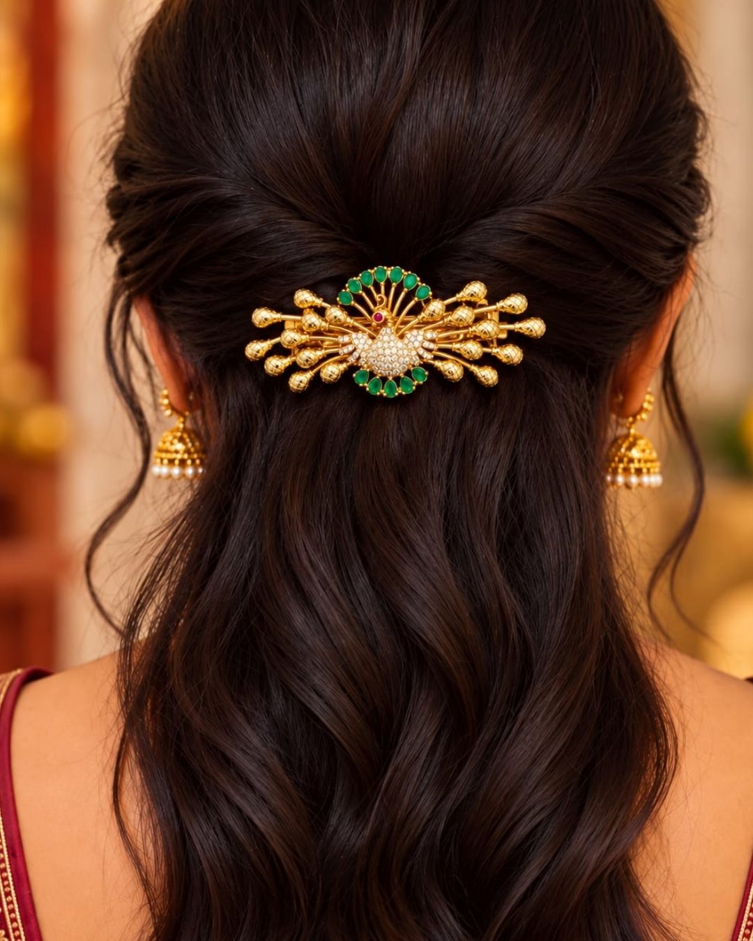 Traditional gold plated designer hair clip featuring an ornate peacock motif surrounded by green stones and sparkling white stones, with multiple decorative gold bead accents, perfect for festive and traditional hairstyles.
