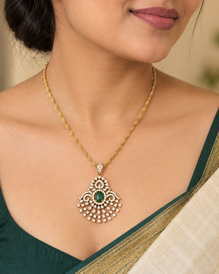 Gold-plated pendant necklace and matching earrings The pendant and matching earrings feature intricate silver-toned filigree with green stone accents in the center.