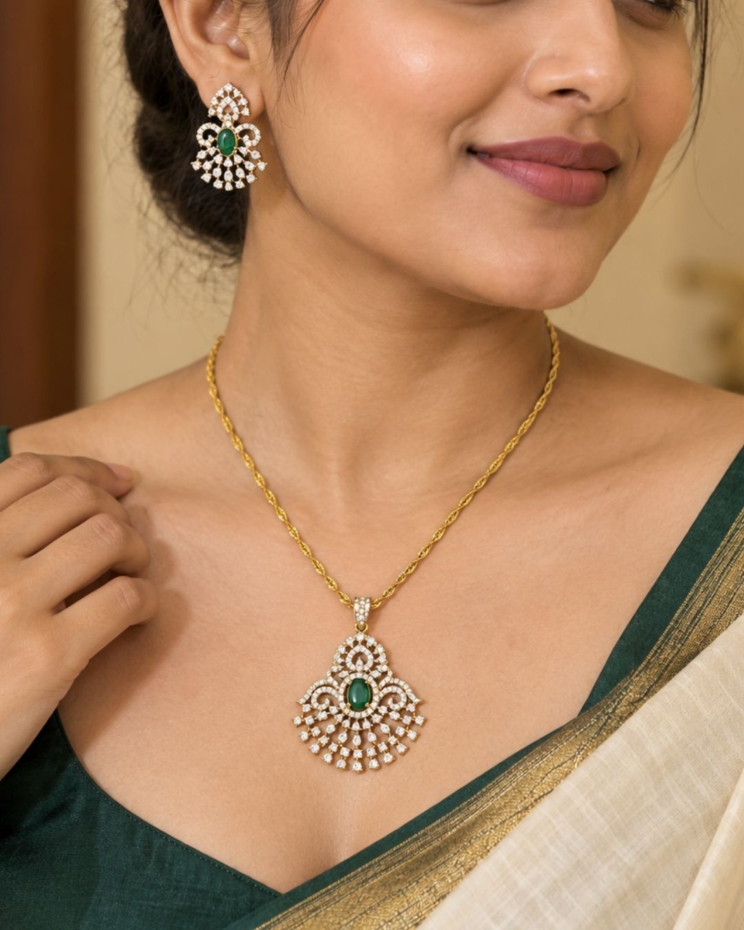 Gold-plated pendant necklace and matching earrings The pendant and matching earrings feature intricate silver-toned filigree with green stone accents in the center.