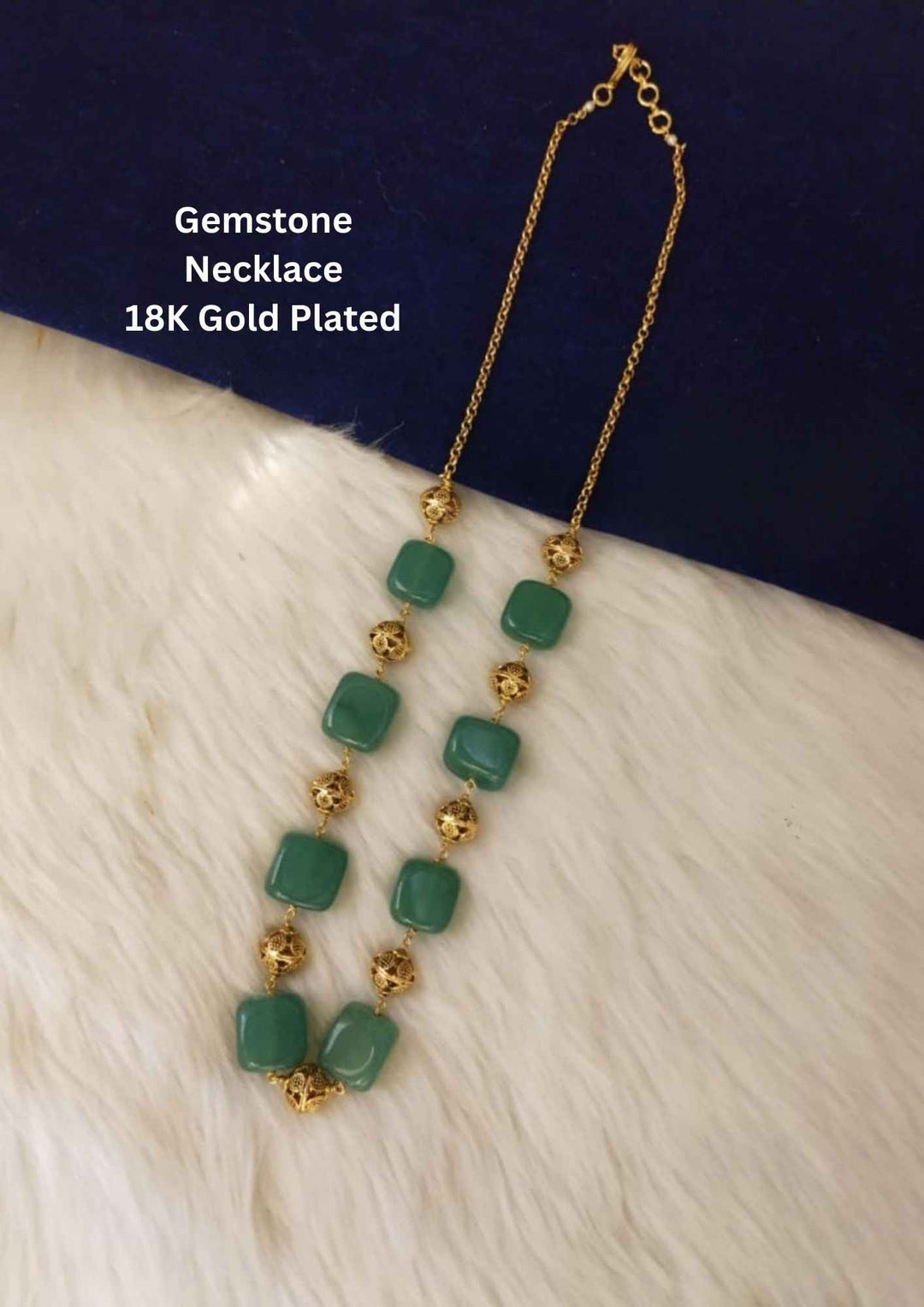 Green gemstone necklace with gold accents