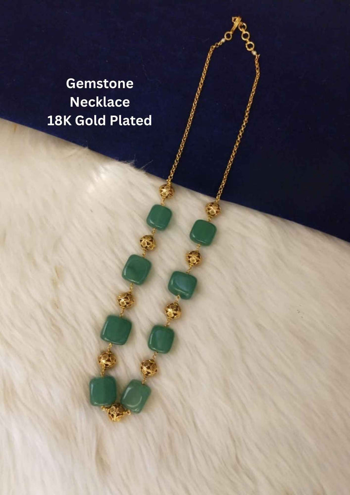 Green gemstone necklace with gold accents