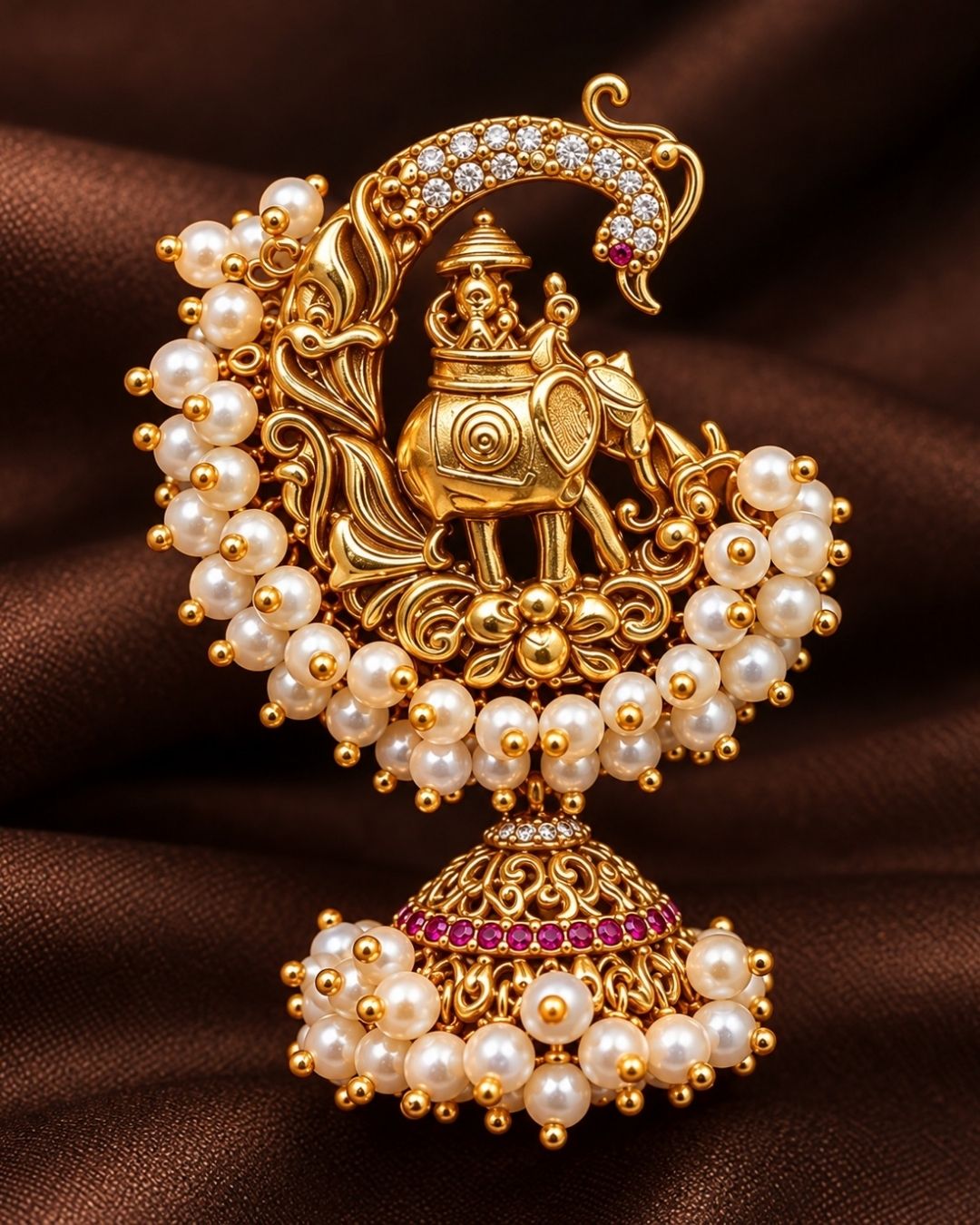 Traditional style Traditional style gold plated Guttapusalu jhumki earrings designed with detailed elephant and peacock structures, pink stone accents, and bunch clusters of hanging white pearls that give a gracegold plated Guttapusalu jhumki earrings designed with detailed elephant and peacock structures, pink stone accents, and bunch clusters of hanging white pearls that give a graceful traditional look for festive celebrations, poojas, family functions, and bridal outfits with lightweight comfortable use
