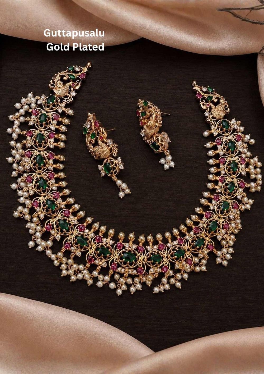 Gold-plated necklace and earrings south indian Woman wearing a traditional necklace and earrings Gold-plated necklace and earrings set with pearls and gemstones comes with jadau kundan and it comes with in detailed peacock design and  comes with pearl beads and looks traditional for weeding , functional 
