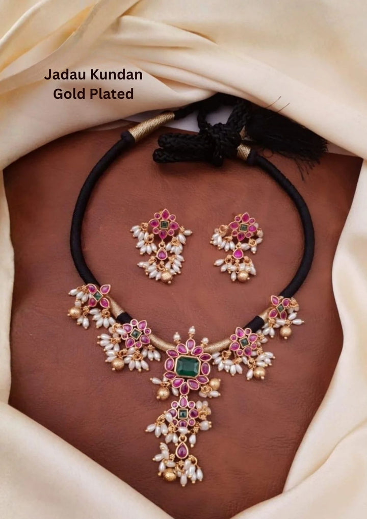 Jadau Kundan Gold Plated Necklace With Earrings designed with red kempu and white stones, and hanging with guttapusallu white rice beads. It is lightweight, comfortable to wear, sweat-proof, anti-fade, skin-friendly, and perfect for daily use, pooja, weddings, and festivals.