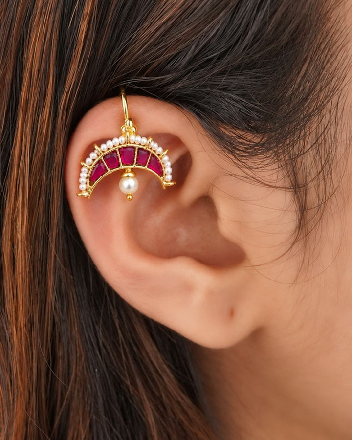 Premium gold plated bugadi earrings featuring an elegant half-moon design embellished with ruby-colored stones, a pearl border, and delicate hanging pearl drops. Perfect for weddings, festive occasions, traditional wear, parties, and gifting.