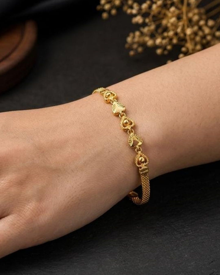Stylish gold plated peacock design bracelet featuring intricate traditional motifs, vibrant green and ruby stone accents, sparkling white detailing, and an elegant linked pattern. Perfect for festive occasions, traditional outfits, weddings, parties, and special events.