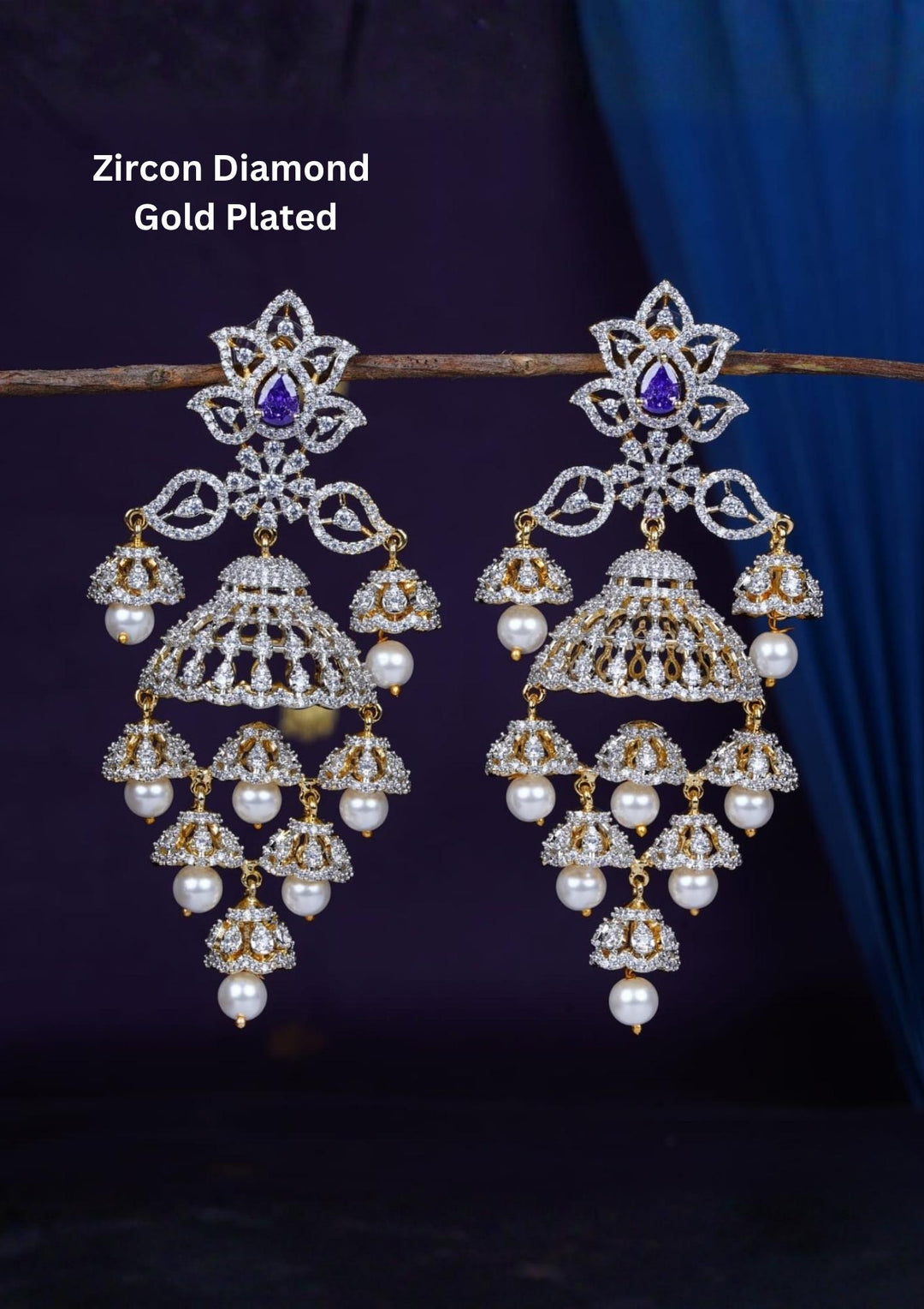 Gold-plated zircon diamond finish multi-tier jhumka earrings designed with dazzling CZ crystals, with a purple tear-drop accent stone, and delicate hanging white pearls that give a graceful traditional and modern look for receptions, sangeet, luxury weddings, and party wear styling with lightweight comfortable use and COD available now.