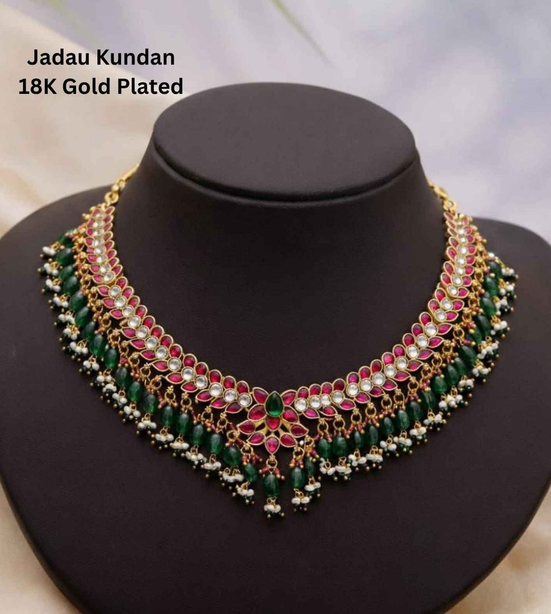 Gold-plated necklace with green and red accents