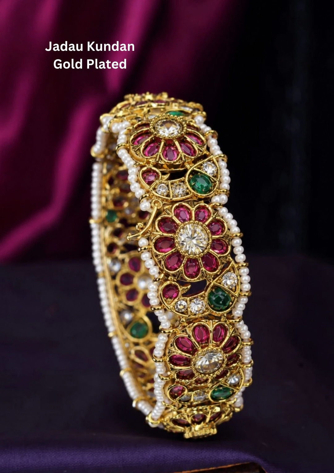 Beautiful Jadau Kundan gold plated floral kada featuring ruby and green stones, dazzling kundan work, intricate craftsmanship, and pearl borders. Perfect for weddings, festivals, temple visits, traditional attire, special occasions, and premium gifting.