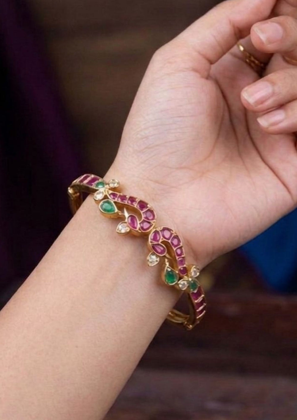 gold plated abstract twin peacock multi gemstone openable kada with an inset showing the spring-hinge mechanism that gives a graceful traditional and modern look for stackable festive wear with COD.