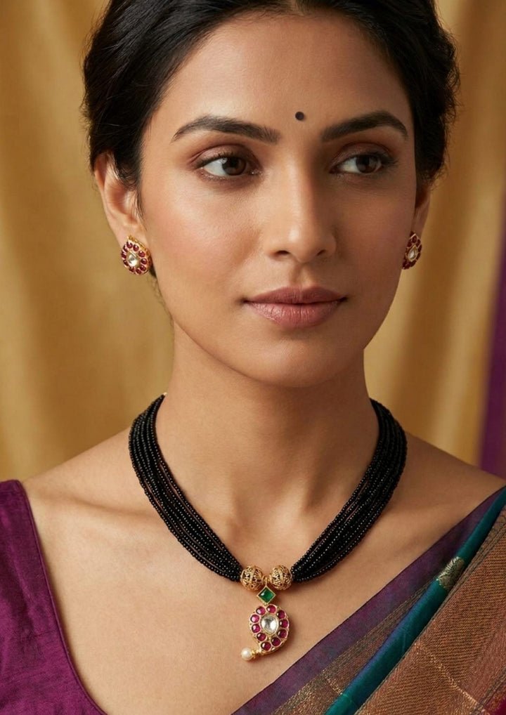 South Indian woman wearing kundan mangalsutra designed with mango shaped using red stones and pearls with gold beads and the mangalsutra designed with small black beads . elegant ethnic look, and traditional daily wear, wedding look, functions.