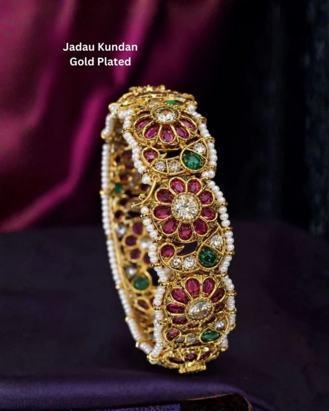 Beautiful Jadau Kundan gold plated floral kada featuring ruby and green stones, dazzling kundan work, intricate craftsmanship, and pearl borders. Perfect for weddings, festivals, temple visits, traditional attire, special occasions, and premium gifting.
