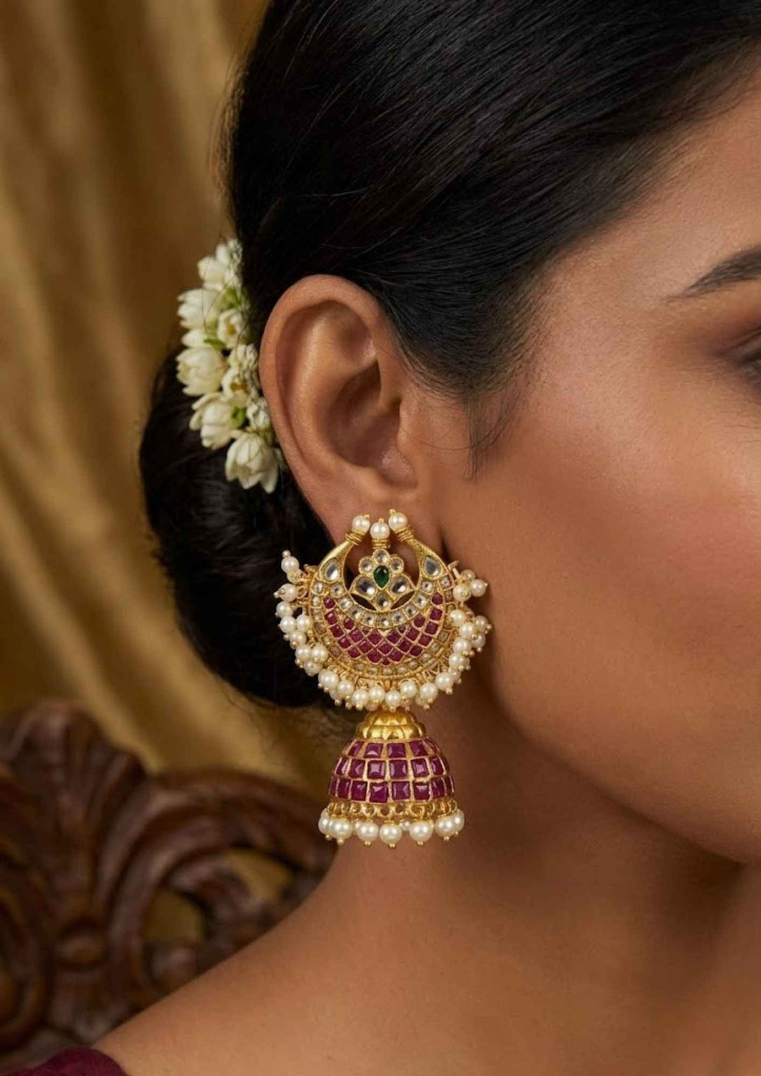South Indian women wearing a  Close-up of traditional earring which shows how women will look and used real kempu in earrings and can be used for traditional wear and it is sweat proof and also lightweight jhumkas