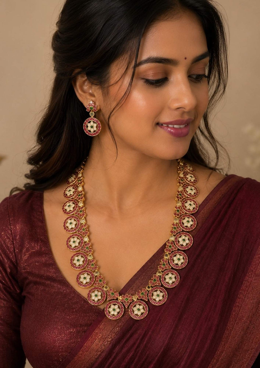South Indian women wearing a Elegant Jadau Kundan gold plated long necklace set featuring ruby-toned floral motifs with matching designer earrings for bridal and festive wear.