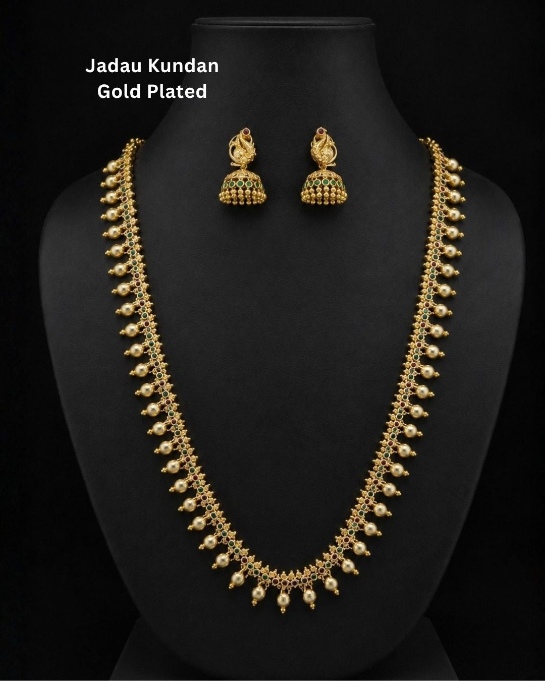 Beautiful gold plated necklace set featuring intricate green and ruby stonework, delicate pearl drop embellishments, and matching peacock-inspired jhumka earrings. Perfect for weddings, bridal wear, festive occasions, traditional outfits, parties, and gifting.