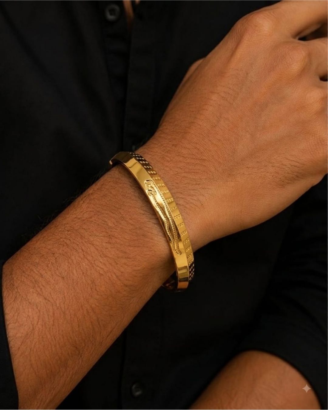 South indian mens A gold-plated men's kada bangle bracelet with engraved patterns, displayed on a dark wooden surface against a black background with text overlay reading 'Men's Kada Gold Plated'.