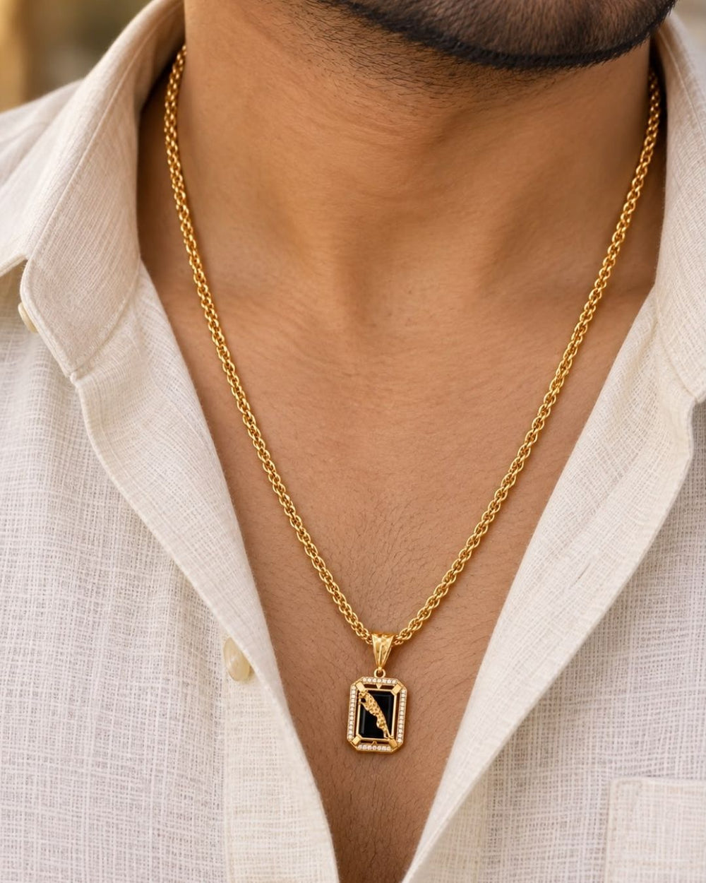 Beautiful gold plated pendant featuring a polished black onyx-style center, intricate peacock motif, decorative gold frame, and sparkling stone detailing, perfect for festive occasions, parties, weddings, and traditional looks.