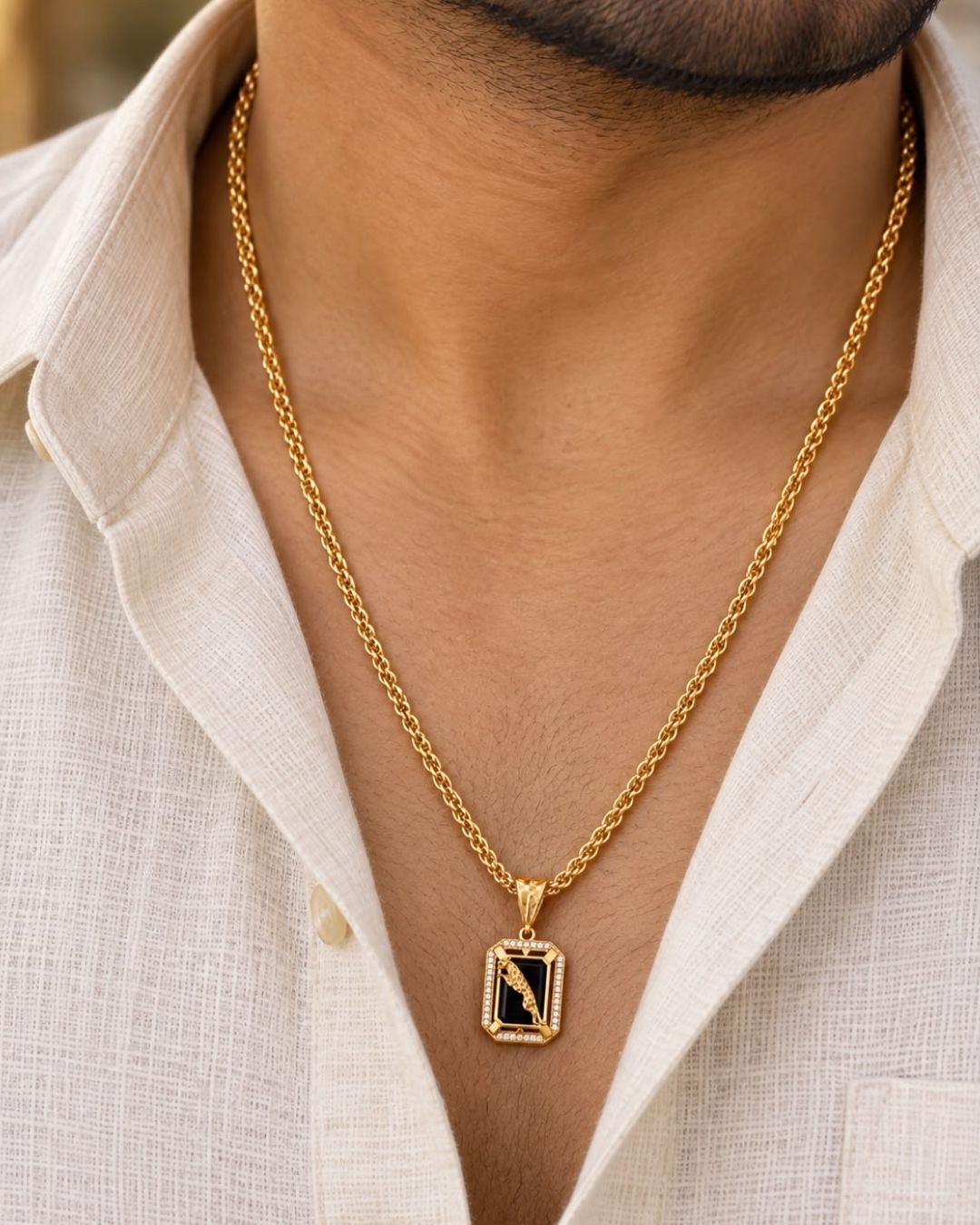 Beautiful gold plated pendant featuring a polished black onyx-style center, intricate peacock motif, decorative gold frame, and sparkling stone detailing, perfect for festive occasions, parties, weddings, and traditional looks.