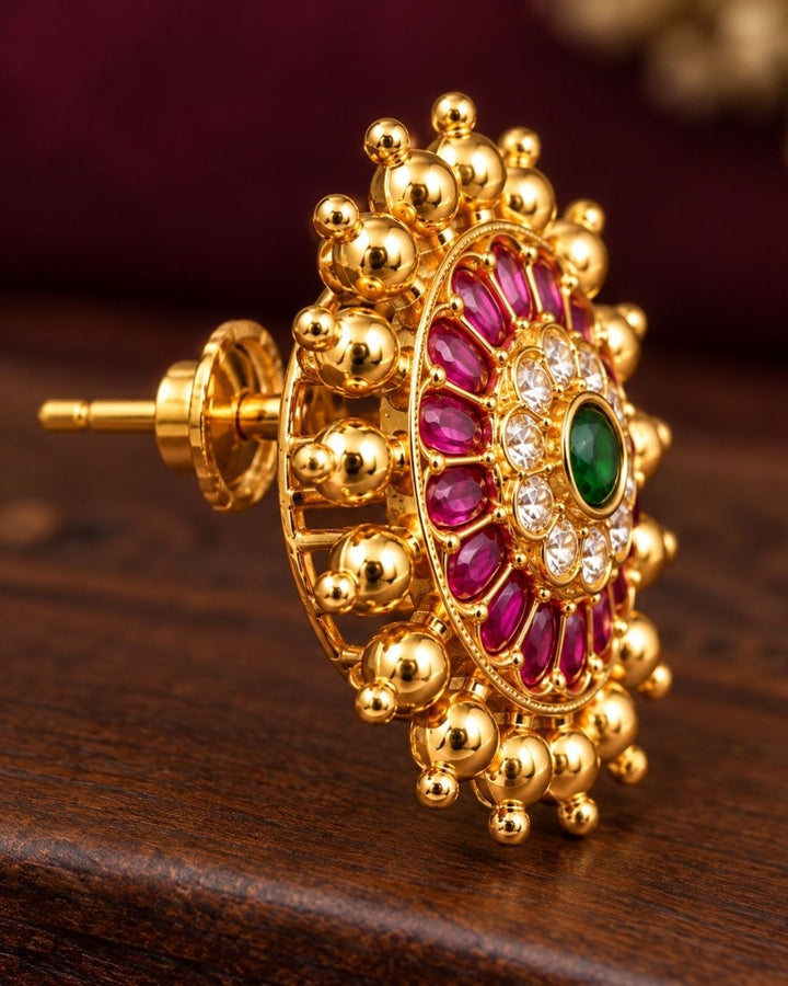 Close-up of a gold earring with gemstones with  looks very traditional and elegant can use for dailyware , functional ware, festive ware and for gift 