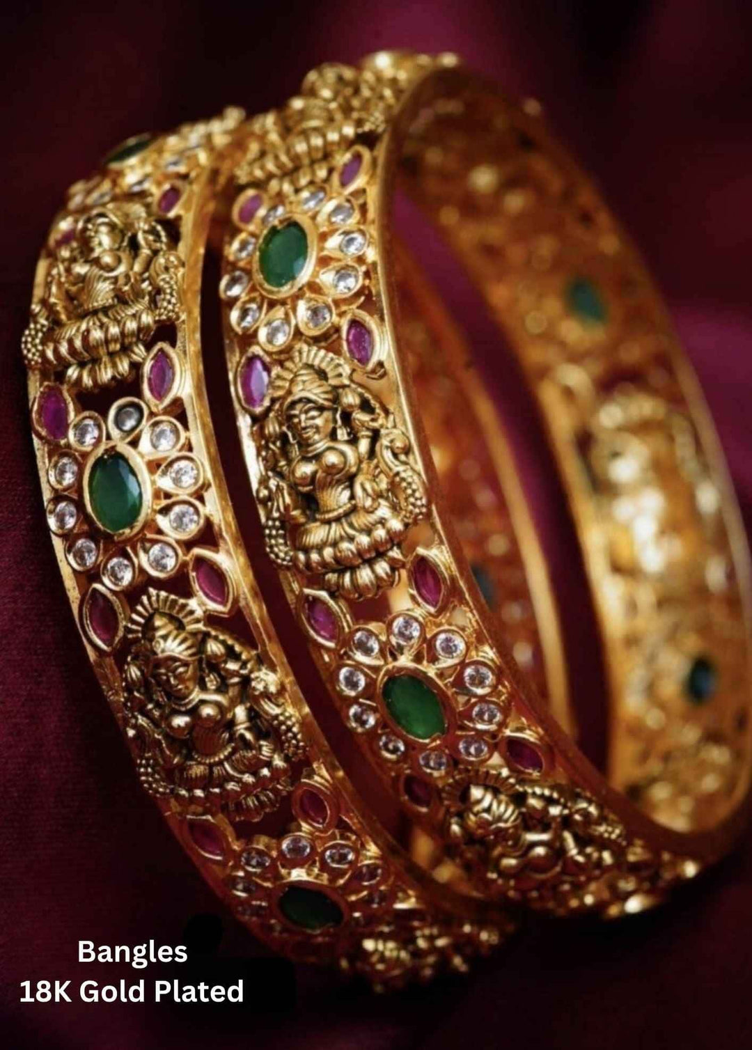 Gold-plated bangles with intricate designs and gemstones