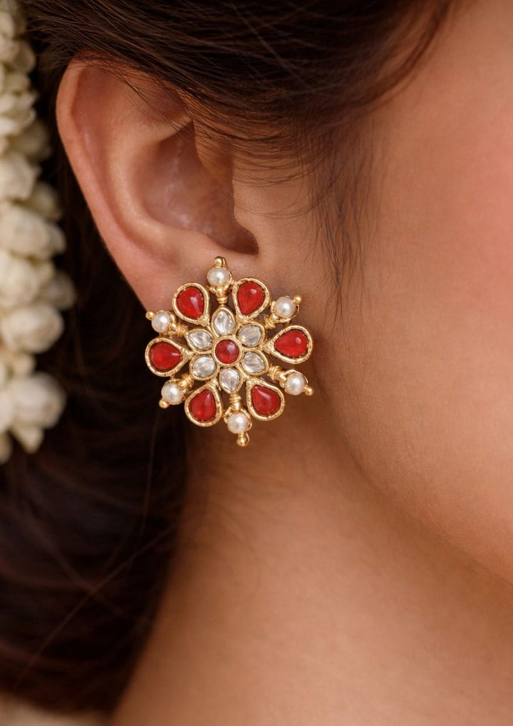 South indian women wearing a Traditional coral jhumkas gold plated screwback earrings The earrings are adorned with vibrant coral red bead danglers and detailed antique gold finish patterns, creating a rich South Indian ethnic look suitable for weddings, festivals, poojas and cultural celebrations