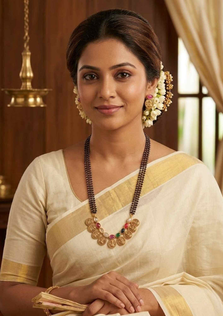 south indian women wearing a Traditional style 18k gold plated Navaratna mangalsutra set designed with a multi-layered black bead chain, continuous Laxmi coin charms, and colorful nine-gemstone accents that give a graceful traditional look for daily fashion wear, festive celebrations, poojas, family functions, and bridal outfits.