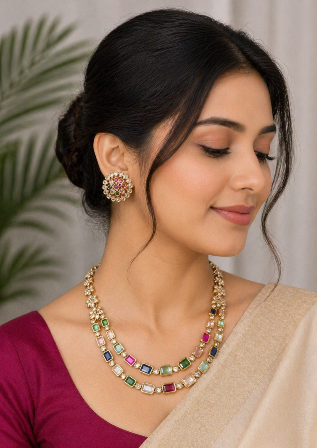 South Indian Woman wearing a gold plated navaratna set with matching studs . this chain was designed in flower model and gemestones are placed inrectangular cuts and this chain cam ewith matching studs that are designed in flower shapr with zircon stones thhis is anti fade color and partywear, receptions and perfect for weddings
