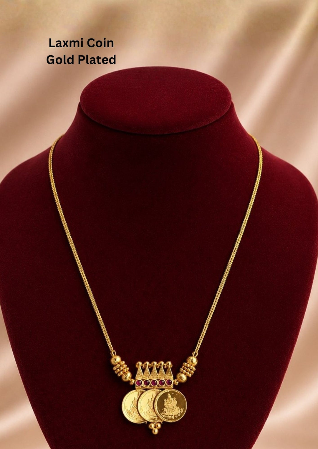 Beautiful gold plated necklace showcasing sacred Lakshmi coin charms and a finely crafted temple-inspired centerpiece.
Designed with elegant ruby stone accents and lightweight construction for comfortable everyday or festive wear.
A perfect traditional jewelry piece to pair with sarees, lehengas, and bridal attire.