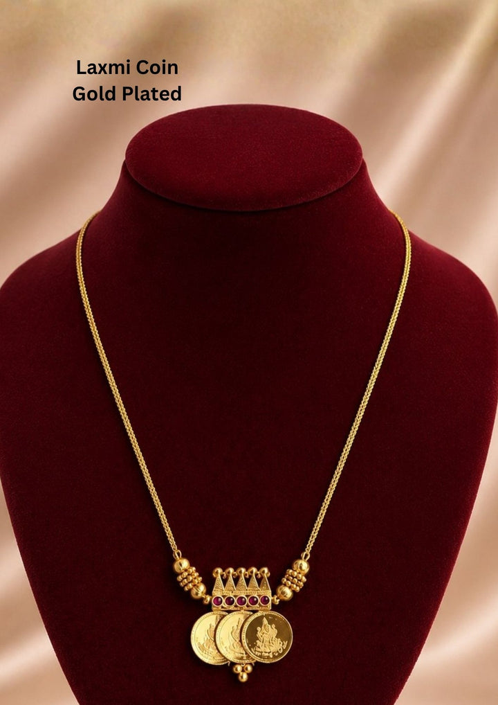 Beautiful gold plated necklace showcasing sacred Lakshmi coin charms and a finely crafted temple-inspired centerpiece.
Designed with elegant ruby stone accents and lightweight construction for comfortable everyday or festive wear.
A perfect traditional jewelry piece to pair with sarees, lehengas, and bridal attire.