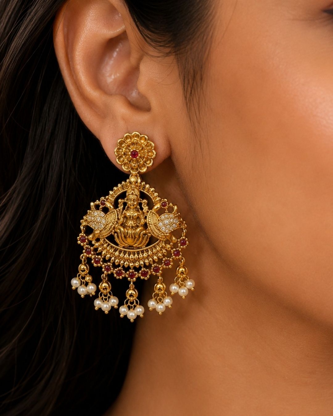 South indian women Beautiful temple-style gold plated jewellery set featuring an elaborate necklace adorned with peacock motifs, green and ruby stones, intricate traditional detailing, and cascading pearl drops, paired with matching earrings.