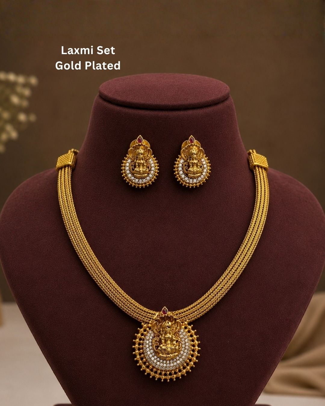 Beautiful Lakshmi gold plated necklace set featuring an intricate Goddess Lakshmi pendant surrounded by white stone detailing and traditional bead accents, paired with matching earrings. Perfect for festive occasions, weddings, temple visits, traditional outfits, and gifting.
