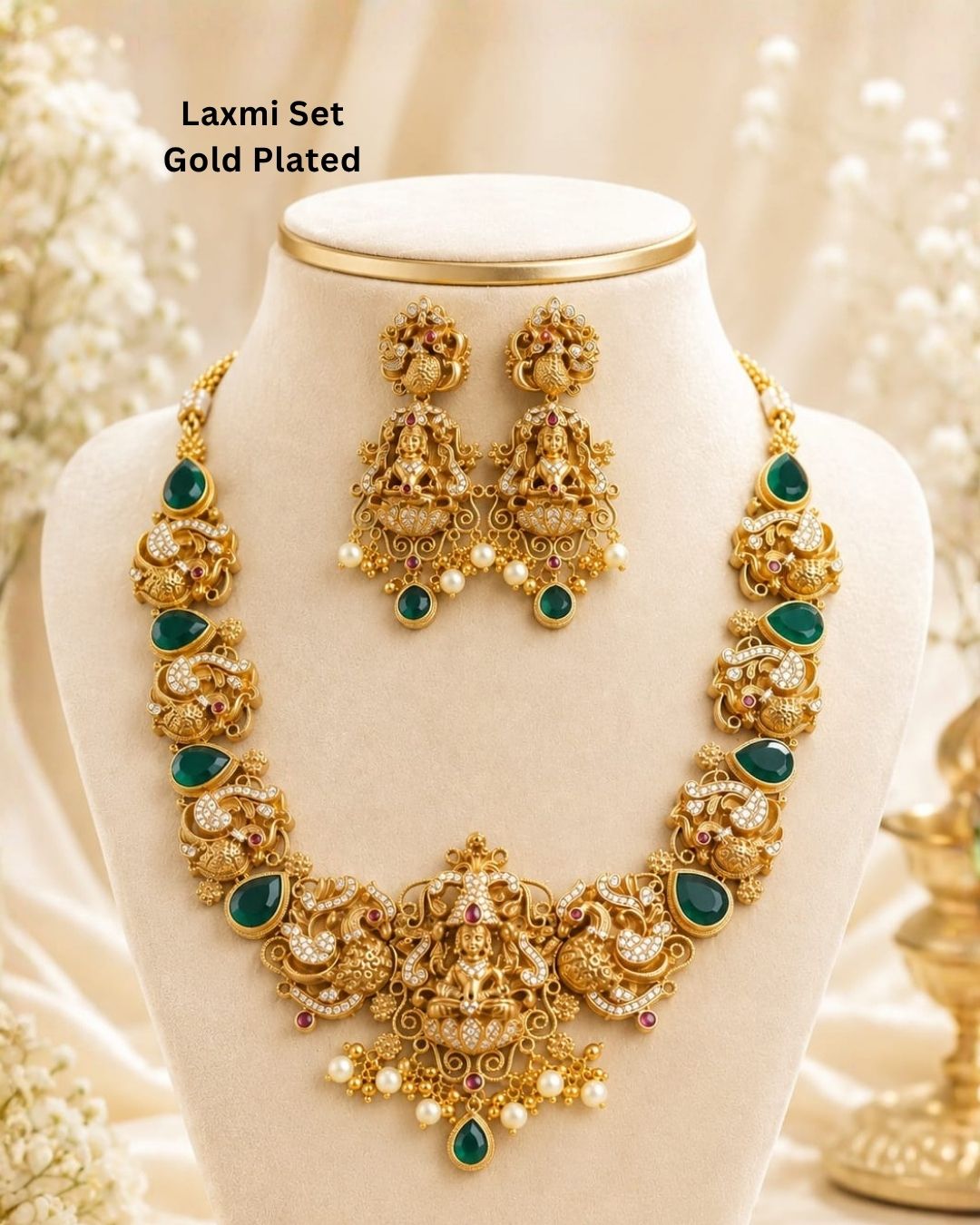 Premium antique gold plated Lakshmi necklace and earrings set crafted with intricate temple-inspired detailing, sparkling stones, green accents, and pearl embellishments.