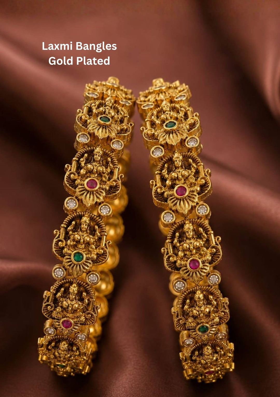 Traditional Lakshmi temple gold plated bangles featuring intricately carved Goddess Lakshmi motifs with ruby, emerald, and zircon accents. Perfect for weddings and festive occasions.