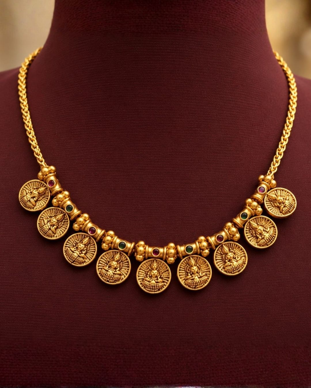 Antique gold plated South Indian coin necklace set with Goddess Lakshmi motifs and matching earrings for festive and traditional wear.