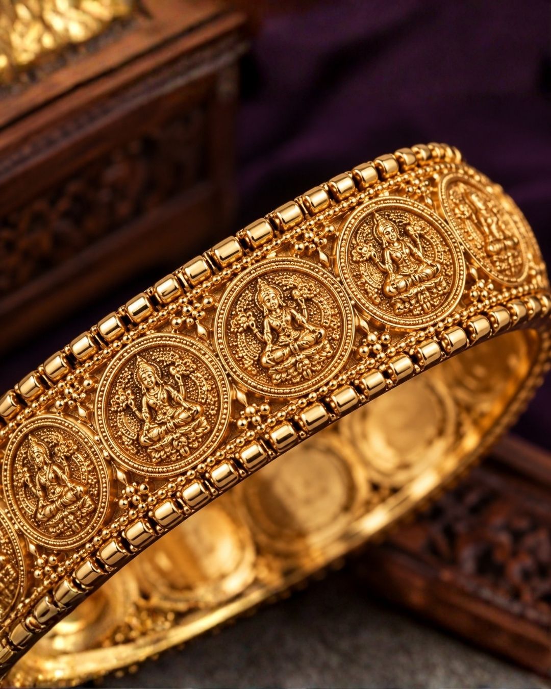 Close-up of a south Indian woman wearing Laxmi Kasula Bangles with traditional Lakshmi coin designs showing Goddess Lakshmi sitting on a lotus flower. The bangles give a rich traditional gold jewelry look with shiny finish, lightweight comfort, sweat proof quality, anti-fade colour, skin-friendly finish, and are suitable for weddings, festivals, functions, celebrations, and weddings.