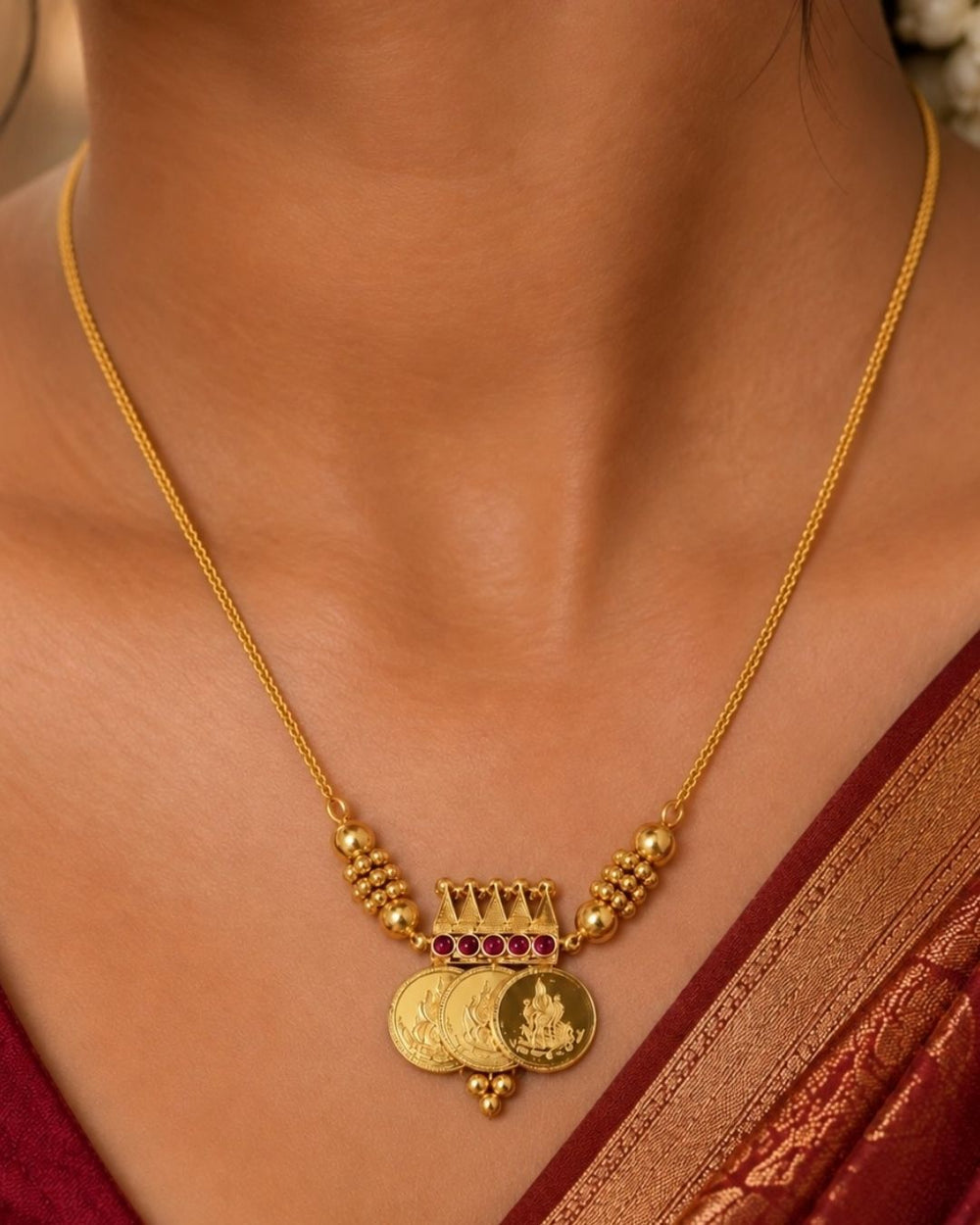 Close up offer south indian women wearing Beautiful gold plated necklace showcasing sacred Lakshmi coin charms and a finely crafted temple-inspired centerpiece.
Designed with elegant ruby stone accents and lightweight construction for comfortable everyday or festive wear.