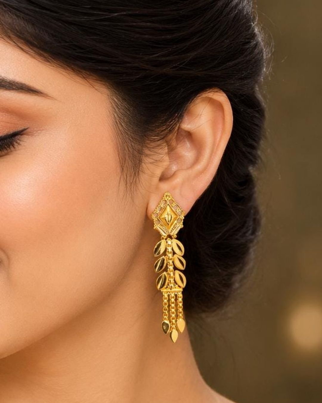 Shop Traditional Gold Plated Leaf Drop Earrings featuring intricate geometric detailing, elegant leaf motifs, and cascading chain accents. Perfect for festive occasions, sarees, weddings, and traditional wear. COD available at Zevana.