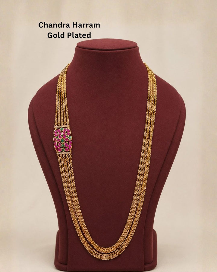 Beautiful multicolor stone gold plated long necklace featuring multiple layered chains and a detailed pink and green stone pendant. Perfect for festive occasions, traditional outfits, parties, temple visits, and gifting.